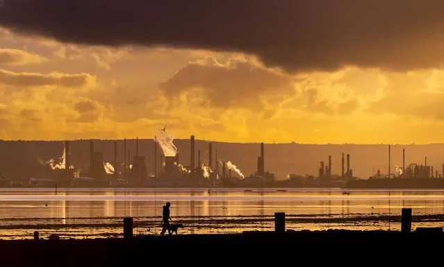 The world turns amber as the sun sets on the Firth of Forth and Grangemouth oil refinery in United Kingdom early November 2022. (Photo by Phil Wilkinson/The Times)