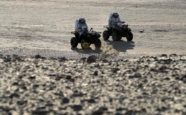 Members of the AMADEE-18 Mars simulation mission ride all-terrain vehicles while wearing spacesuits during an analog field simulation in Oman's Dhofar desert on February 7, 2018, in a collaboration between the Austrian Space Forum and the Oman National Steering Comittee preparing for future human Mars missions. (Photo by Karim Sahib/AFP Photo)
