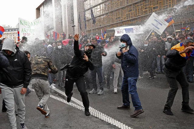 Police use a water cannon to disperse pro-Armenia protesters near EU institutions in Brussels, Wednesday, October 7, 2020. The intense shelling in the separatist region of Nagorno-Karabakh is taking its toll on the civilian population as fighting between Armenian and Azerbaijani forces showed no signs of abating Wednesday. (Photo by Francisco Seco/AP Photo)