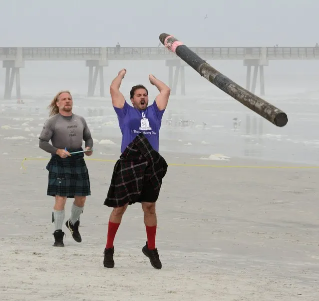 Matt Hopcraft competes in the novice division of the caber toss as contestants flip a 14' 80-90 lb. pole for accuracy. The pole must make a complete flip and the closer to perpendicular the better the score. Lannadoo, is the second annual Celtic festival at  the SeaWalk Pavilion in Jacksonville Beach, Fla., on Sunday November 23, 2014. The weekend-long festival showcased the best of the Celtic nations through culture, music and heritage. (Photo by Bob Mack/AP Photo/The Florida Times-Union)