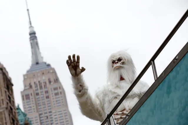 An actor dressed as a “Yeti” waves from a tour bus during a promotional event for Travel Channel's “Expedition Unknown: Hunt for the Yeti” in Manhattan, New York City, U.S., October 4, 2016. (Photo by Brendan McDermid/Reuters)