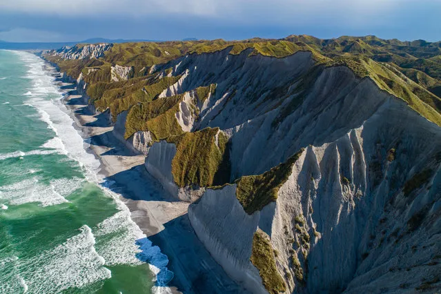 An aerial view of the White Cliffs on Iturup Island, the largest one of the Kuril Islands, situated in the southern part of its Greater Kuril Chain, Sakhalin Region, Russia on October 15, 2020. (Photo by Yuri Smityuk/TASS)