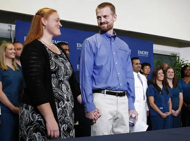 Kent Brantly, who contracted the deadly virus Ebola, looks at his wife Amber during a news conference at Emory University Hospital in Atlanta, Georgia, in this August 21, 2014 file photo. (Photo by Tami Chappell/Reuters)