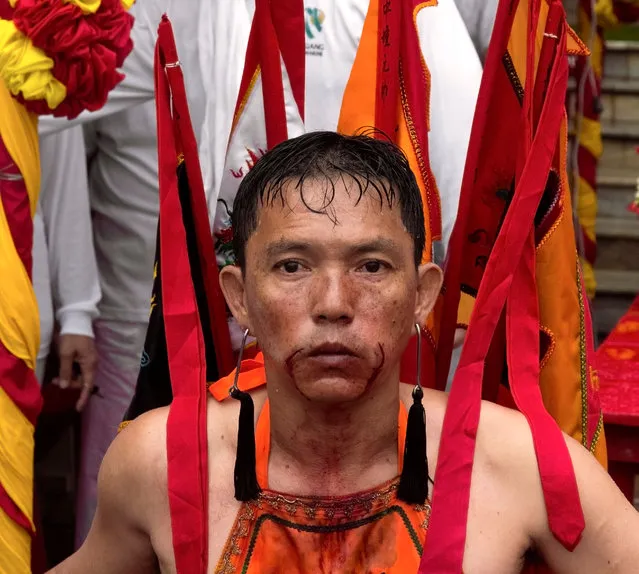A spirit medium) has just had his face piercings extracted during the Phuket Vegetarian Festiva. Image shot 2011. Exact date unknown. (Photo by Alamy Stock Photo)