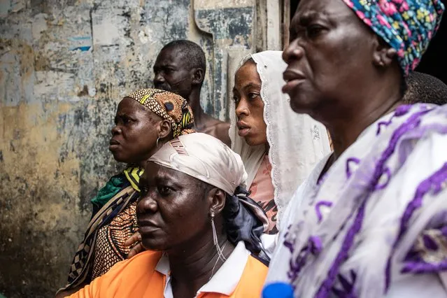People watch as ballot papers are counted at a polling station in Alimosho, Lagos, on February 25, 2023, during Nigeria's presidential and general election. (Photo by John Wessels/AFP Photo)