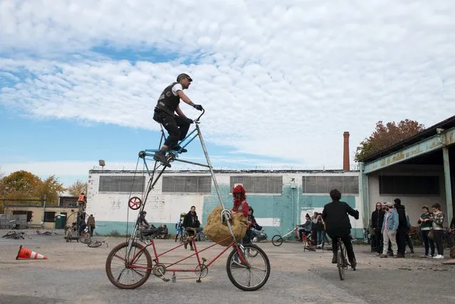 A man rides a tall bike during "Bike Kill 12" in the Brooklyn borough of New York City, October 31, 2015. (Photo by Stephanie Keith/Reuters)