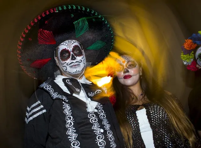 Participants gather before the start of a candlelight procession at the end of a three-day "Day of The Dead" (Dia de los Muertos) celebration in Old Town San Diego, California November 2, 2015. (Photo by Mike Blake/Reuters)