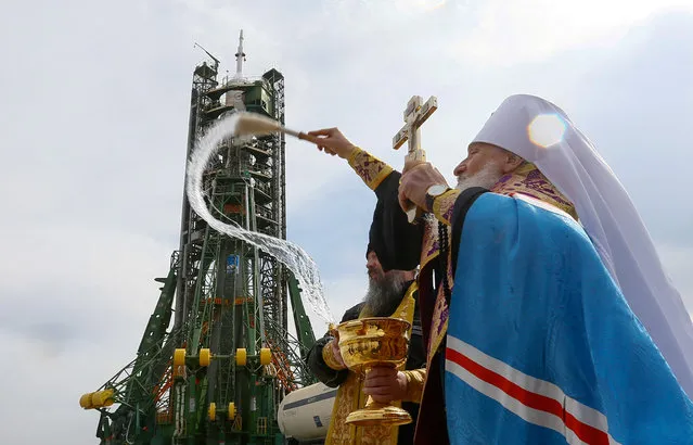 An Orthodox priest conducts a blessing in front of the Soyuz MS-08 spacecraft set on the launchpad ahead of its upcoming launch with International Space Station (ISS) crew, at the Baikonur Cosmodrome in Kazakhstan March 20, 2018. (Photo by Shamil Zhumatov/Reuters)