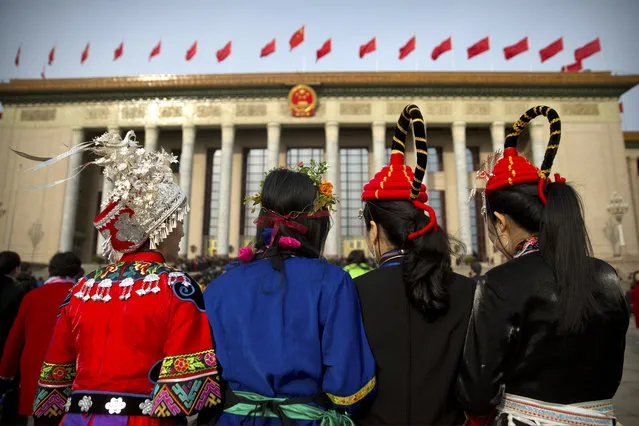 Delegates in ethnic minority dress arrive for the closing session of China's National People's Congress (NPC) at the Great Hall of the People in Beijing, Tuesday, March 20, 2018. (Photo by Mark Schiefelbein/AP Photo)