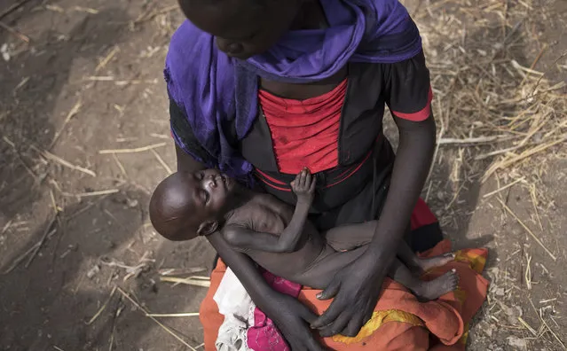 In this April 5, 2017, file photo, Adel Bol, 20, cradles her 10-month-old daughter Akir Mayen at a food distribution site in Malualkuel, in the Northern Bahr el Ghazal region of South Sudan. The United Nations humanitarian office said Wednesday, November 18, 2020 it is releasing $100 million in emergency funding to seven countries at risk of famine in Africa and the Middle East amid conflict and the COVID-19 pandemic, while the humanitarian chief says returning to a world where famines are common would be “obscene”. (Photo by AP Photo/File)