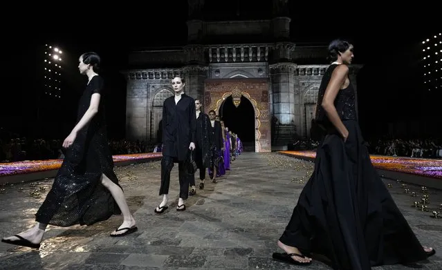 Models display creations for the Dior Pre-Fall 2023 collection at the Gateway of India landmark monument in Mumbai, India, Thursday, March 30, 2023. (Photo by Rafiq Maqbool/AP Photo)