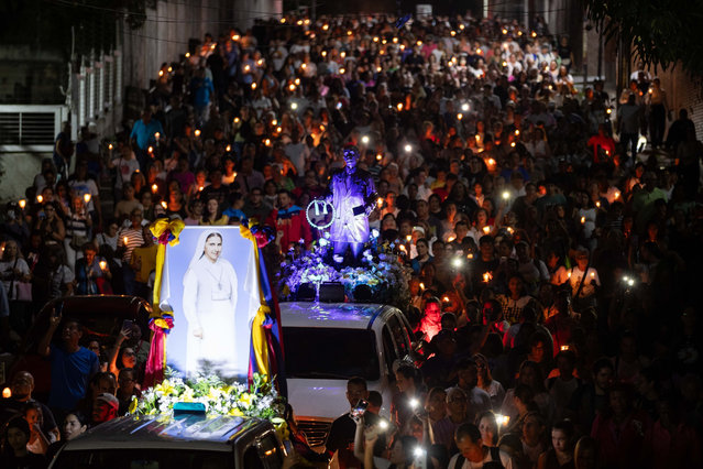 A procession in Caracas, Venezuela, 04 October 2025 honours the doctor José Gregorio Hernández and nun Carmen Elena Rendiles Martínez, who are to be canonised and declared as saints of the Catholic church. Candles were lit for peace. (Photo by Ronald Pena R./EPA)