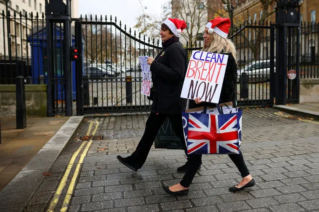 Pro-Brexit supporters carries placards as they walk in Westminster, London, Britain on December 9, 2020. (Photo by Henry Nicholls/Reuters)