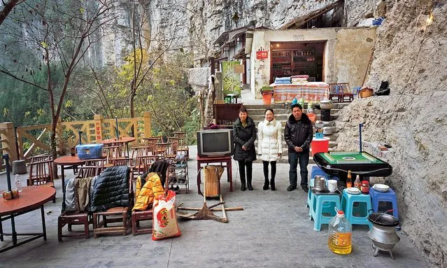 Photographer Ma Hongjie has spent 11 years documenting families in various parts of China for his upcoming book The Family Belongings of Chinese People. Here: a family outside their home in the Xiaozhai Tiankeng sinkhole, Fengjie county. (Photo by Ma Hongjie)