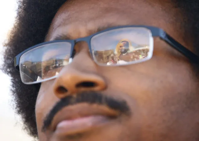 An image of Martin Luther King, Jr., is reflected in Justin Pearson's glasses before a march with supporters to the Shelby County Board of Commissioners meeting in Memphis, Tenn., on Wednesday, April 12, 2023.  Pearson and a colleague were kicked out of the Legislature last Thursday following their support of gun control protesters. (Photo by Chris Day/The Commercial Appeal via AP Photo)