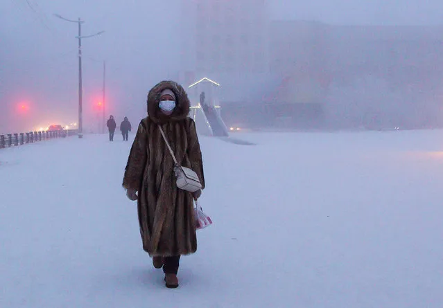 A local woman walks in Lenin Square in freezing conditions of minus 43 degrees Celsius in the city of Yakutsk, Sakha (Yakutia), Russia on December 13, 2020. (Photo by Yevgeny Sofroneyev/TASS)