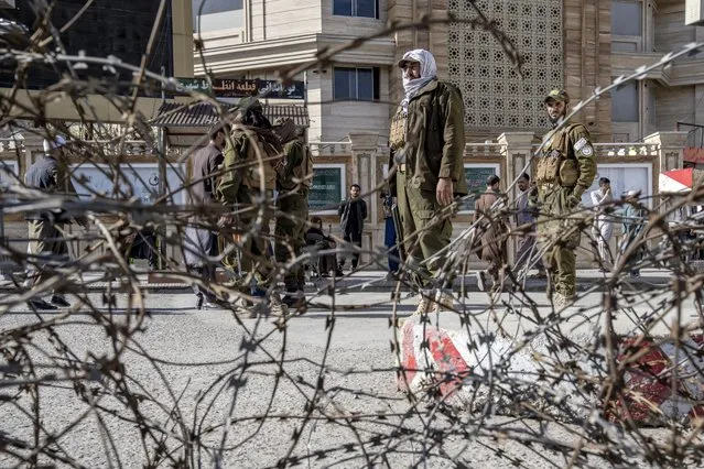 Taliban fighters stand guard at the explosion site, near the Foreign Ministry in Kabul, Afghanistan, Monday, March 27, 2023. A suicide bomber has struck near the foreign ministry in the Afghan capital, killing at least six people and wounding about a dozen. (Photo by Ebrahim Noroozi/AP Photo)