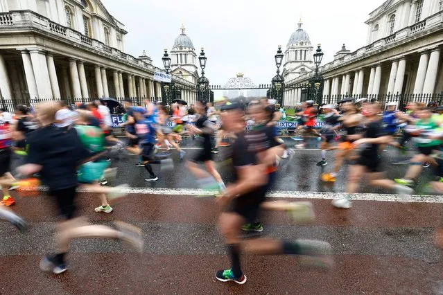 Runners in the London Marathon pass the Old Royal Naval College in Greenwich, London, United Kingdom on April 23, 2023. (Photo by Peter Cziborra/Reuters)