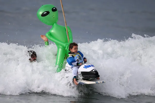 Oliver Quiros, 3, competes dressed as an astronaut in a space shuttle in the Haunted Heats Halloween Surf Contest in Santa Monica, California, U.S., October 29, 2016. (Photo by Lucy Nicholson/Reuters)
