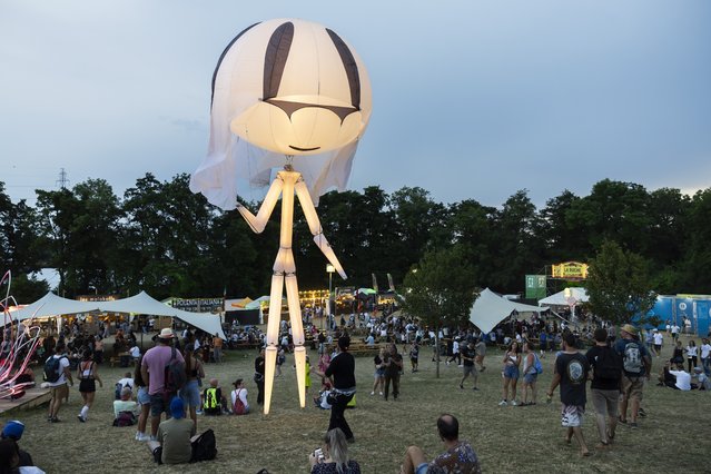 Celeste,a giant luminous inflatable puppet, from the French Company Inko'Nito, performs, during the Paleo Festival in Nyon, Switzerland, 27 July 2024. The Paleo is an open-air music festival running from 23 to 28 July. More than 250,000 visitors are expected during the festival. (Photo by Salvatore di Nolfi/EPA/EFE)