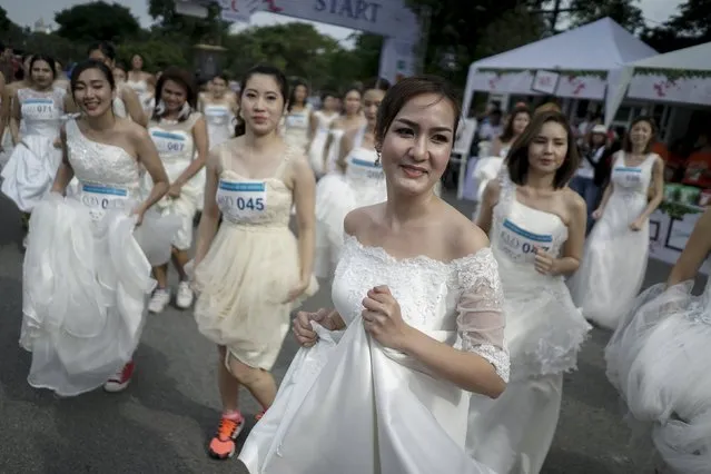 Brides-to-be participate in the "Running of the Brides" race in a park in Bangkok, Thailand, November 28, 2015. (Photo by Athit Perawongmetha/Reuters)