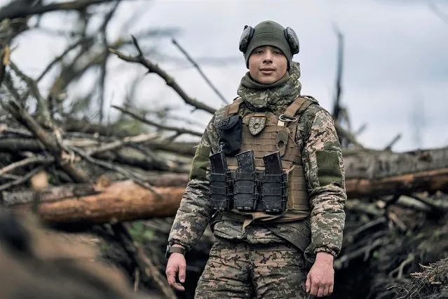 A Ukrainian soldier looks on as he stands in a trench on the frontline near Avdiivka, an eastern city where fierce battles against Russian forces have been taking place, in the Donetsk region, Ukraine, Friday, April 28, 2023. (Photo by Libkos/AP Photo)