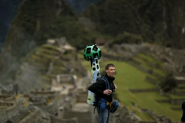 Daniel Filip, Tech Lead Manager for Google Maps, carries the Trekker, a 15-camera device, while mapping the Inca citadel of Machu Picchu for Google Street View in Cuzco, Peru, August 11, 2015. (Photo by Pilar Olivares/Reuters)