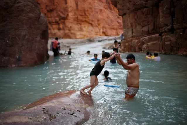 People swim in a river in the Valley of al-Zara, which flows into the Dead Sea, in Jordan, November 5, 2016. (Photo by Muhammad Hamed/Reuters)
