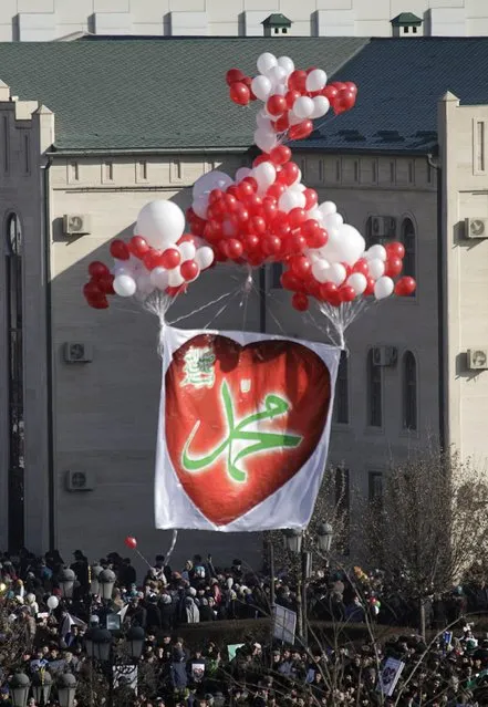 People display balloons and a banner reading, “Mohammad” at a rally to protest against satirical cartoons of prophet Mohammad, in Grozny, Chechnya January 19, 2015. (Photo by Eduard Korniyenko/Reuters)