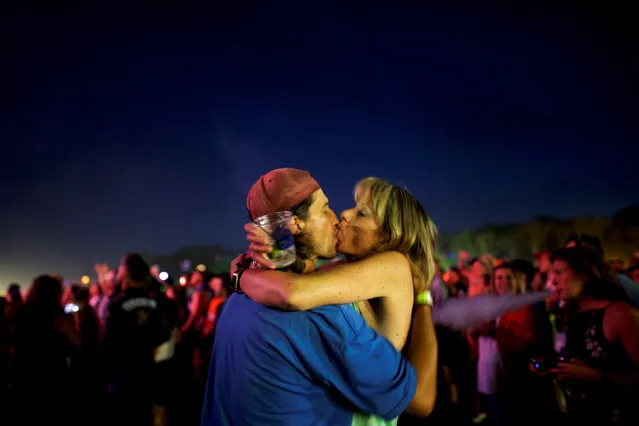 A couple kisses as The Killers perform on the third day of the Firefly Music Festival in Dover, Delaware on June 17, 2018. (Photo by Mark Makela/Reuters)