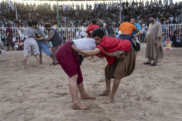 Men wrestle in a local tournament in Herat, Afghanistan, Friday, June 2, 2023. (Photo by Ebrahim Noroozi/AP Photo)