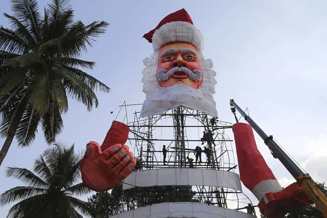 Indian workers make a larger than life size statue of Santa Claus in the premises of St. Joseph's Church ahead of Christmas celebrations in Bangalore, India, Tuesday, December 15, 2015. Though Hindus and Muslims comprise the majority of the population in India, Christmas is celebrated with much fanfare. (Photo by Aijaz Rahi/AP Photo)