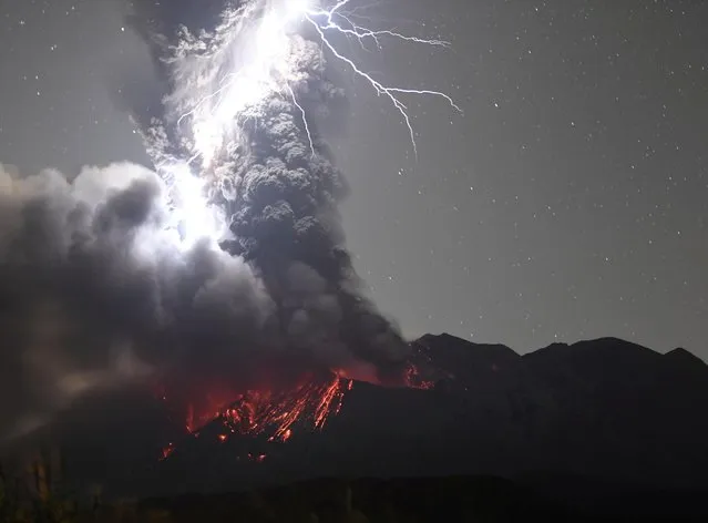 Volcanic lightning over Mount Sakurajima is pictured from Tarumizu city, Kagoshima prefecture, Japan on December 17, 2020. (Photo by Kyodo News via Reuters)