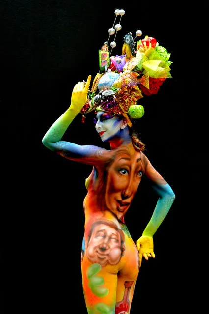 A participant poses with her body paintings designed by bodypainting artist Scott Fray during the 16th World Bodypainting Festival in Poertschach on July 6, 2013 in Poertschach am Woerthersee, Austria. (Photo by Didier Messens/Getty Images)
