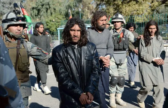 Alleged Taliban militants are presented to the media in Jalalabad, Nangarhar province on December 29, 2015. Afghan border police said they arrested nine alleged Taliban militants with their weapons during clashes in the Nazyan district of Nangarhar province. (Photo by Noorullah Shirzada/AFP Photo)
