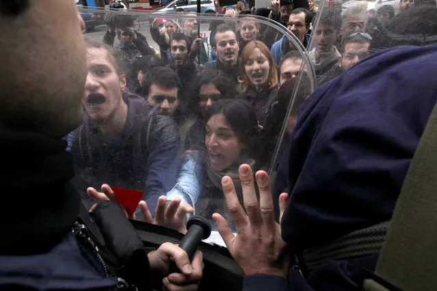 Demonstrators scuffle with riot police officers during a protest against home auctions outside a Bank of Greece branch in Thessaloniki, Greece November 23, 2016. (Photo by Alexandros Avramidis/Reuters)