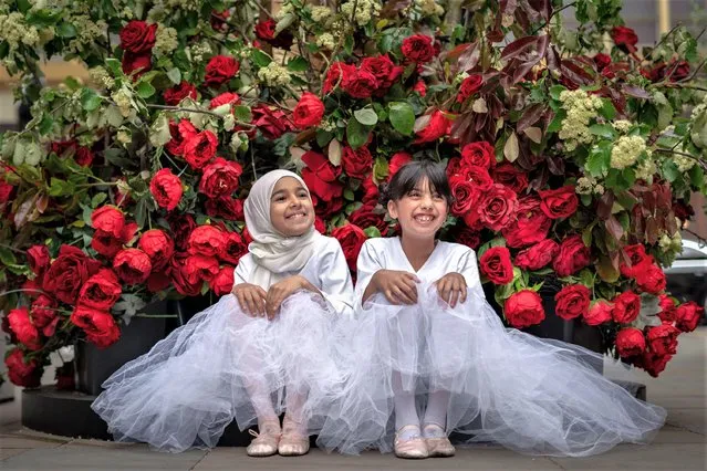 Young dancers from Grace & Poise Academy, the first Muslim Ballet School, pose with the numerous “Flowers on Film” themed floral installations in Chelsea, United Kingdom on May 25, 2023. (Photo by Guy Corbishley/Alamy Live News)