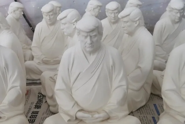 Statues depicting former U.S. President Donald Trump in a Buddhist meditative pose, by Chinese designer Hong Jinshi, are seen at a workshop in Dehua, Fujian province, China on March 24, 2021. (Photo by Martin Pollard/Reuters)