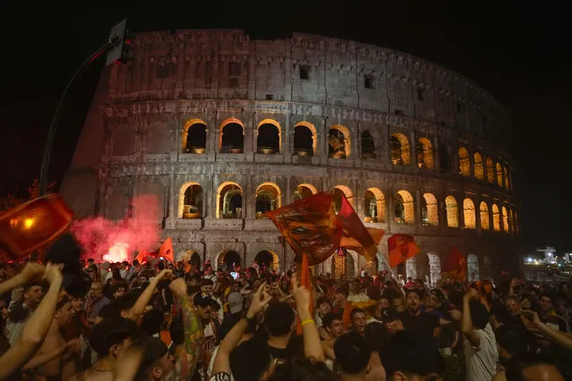 Supporters of AS Roma celebrate in front of the Colosseum in Rome their team's victory of the Europa Conference League final soccer match between Roma and Feyenoord played in Tirana, Wednesday, May 25, 2022. Roma beat Feyenoord 1-0 and conquered the first edition of the trophy. (Photo by Gregorio Borgia/AP Photo)