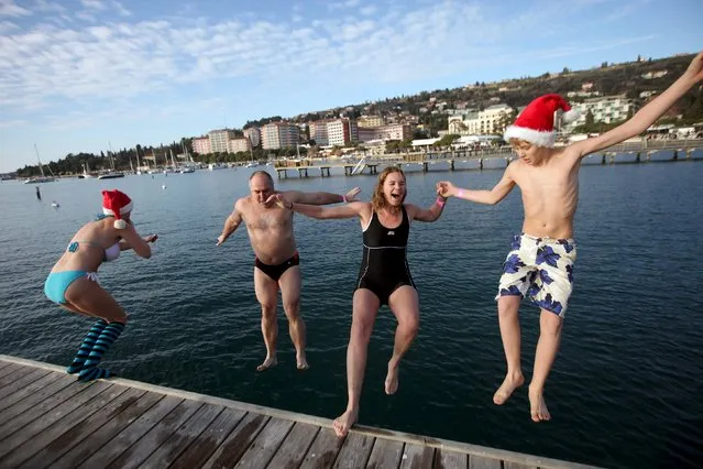 Participants take part in a New Year's Jump into the Sea in Portoroz , Slovenia, January 1, 2016. (Photo by Srdjan Zivulovic/Reuters)