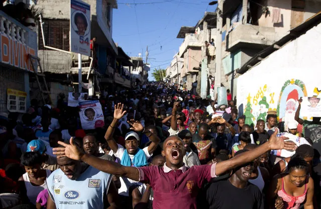 Supporters of presidential candidate Maryse Narcisse, from Fanmi Lavalas political party, chant victory slogans during a protest in Port-au-Prince, Haiti, Monday, November 28, 2016.  Before election results have been announced, supporters of Narcisse assert their candidate has won, and that only electoral fraud would keep her from office. (Photo by Dieu Nalio Chery/AP Photo)