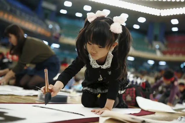 A girl participates in a calligraphy contest to celebrate the New Year in Tokyo January 5, 2016. (Photo by Thomas Peter/Reuters)
