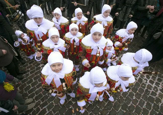Hugo Belleri (L), a three-year-old boy and the youngest Gilles of Binche, takes part in the parade of Young Gilles of Binche during the carnival event in Binche February 17, 2015. (Photo by Yves Herman/Reuters)
