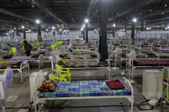 Newly arranged beds lie inside a COVID-19 treatment center set up for emergencies in the wake of spike in the numbers of positive coronavirus cases in Mumbai, India, Thursday, May 6, 2021. (Photo by Rajanish Kakade/AP Photo)