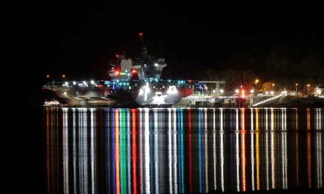 HMS Queen Elizabeth, the Royal Navy’s fleet flagship, docked at night as part of final preparations before her first operational deployment in Glen Mallan, United Kingdom on March 19, 2021. (Photo by POPhot JJ Massey/PA Wire Press Association)