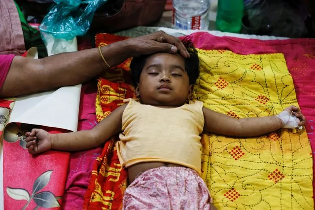 A child suffering from fever lies on a bed after getting hospitalised for treatment at Mugda Medical College and Hospital, as the yearly death toll from dengue has surpassed the previous record in the country, in Dhaka, Bangladesh on September 5, 2023. (Photo by Mohammad Ponir Hossain/Reuters)