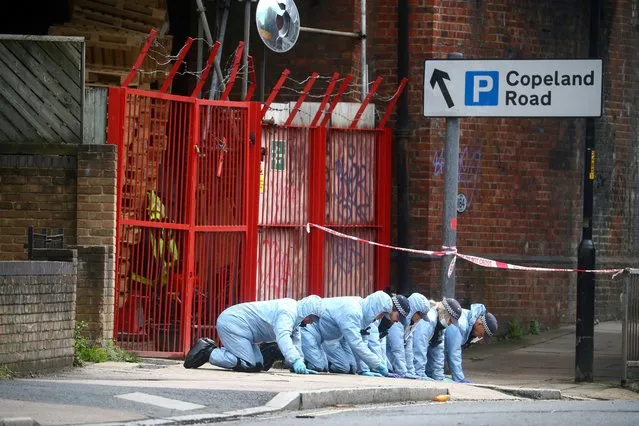 Forensic officers work at the area after Sasha Johnson, a Black Lives Matter activist, was shot in an early morning attack near her home in Peckham, London, Britain, May 24, 2021. (Photo by Hannah McKay/Reuters)