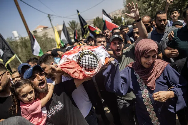 The mother of Palestinian boy Othman Abu Khorg, 17, carries the body of her son, who died after being shot in the head by Israeli soldiers during a raid in the village of Zababdeh, southeast of Jenin on August 22, 2023. (Photo by Bruno Thevenin/SIPA Press/Rex Features/Shutterstock)