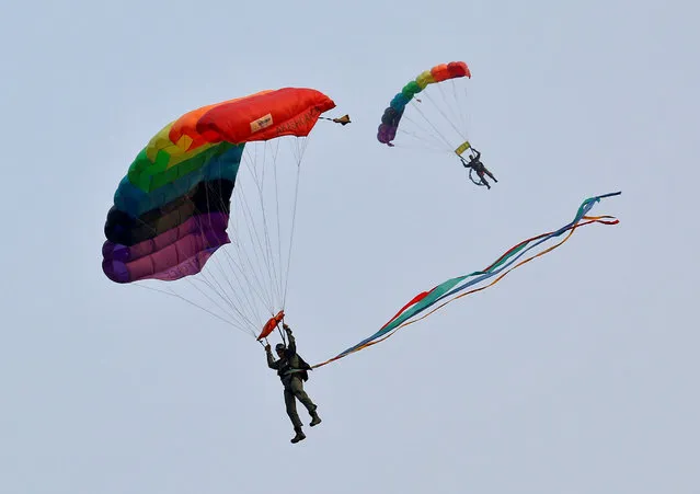 Indian Air Force's “Akash Ganga” sky diving team members perform during an air show during the celebrations of Vijay Diwas, a ceremony to celebrate the liberation of Bangladesh by the Indian Armed Forces on December 16 in 1971, in Kolkata, India, December 14, 2016. (Photo by Rupak De Chowdhuri/Reuters)