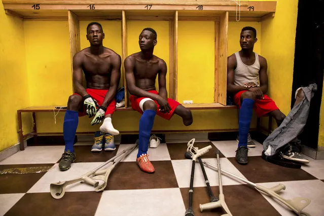 Some players of the Haitian football selection of players with amputated limbs gather in the locker room of the Parc Sainte- Thérèse in Pétion- ville on September 15, 2018, preparing for the fundraising match. Football has long been a national obsession in Haiti, and since the devastating 2010 earthquake – which spurred the creation of a national disabled squad – the country has also become a player to contend with, with its eyes set on victory in November' s amputee World Cup. (Photo by Pierre Michel Jean/AFP Photo)